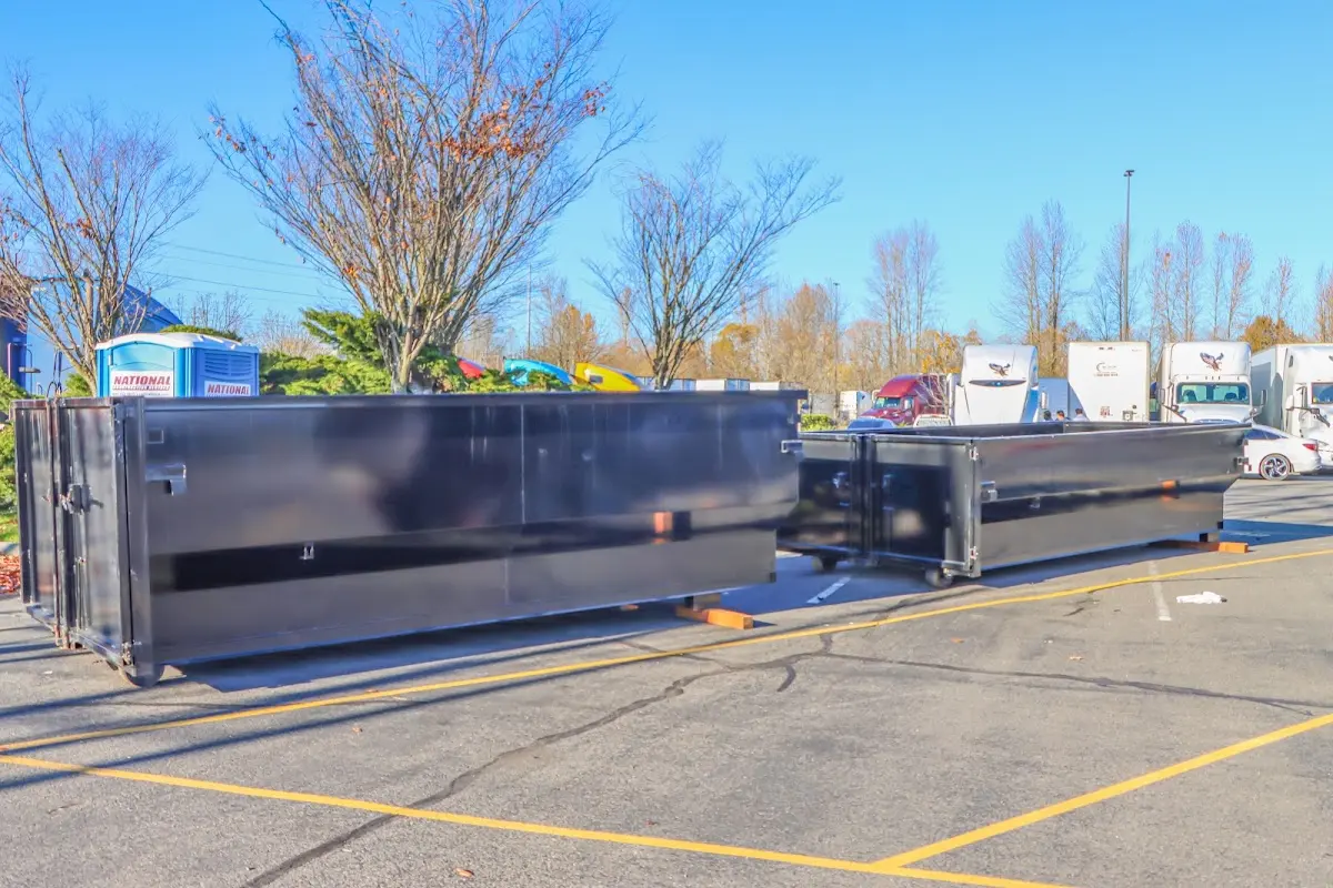 Professional dumpster rental service with roll-off container on residential driveway in Garner